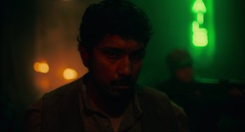 Movie still from “The Forever Purge” (2021), directed by Everardo Gout – A person in a dark room; Close Up shot, Over the shoulder angle