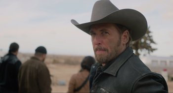 Movie still from “The Forever Purge” (2021), directed by Everardo Gout – A man in a cowboy hat is standing in the desert; Close Up shot, Over the shoulder angle
