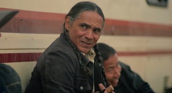 Movie still from “The Forever Purge” (2021), directed by Everardo Gout – An older man with long hair and a beard; Close Up shot, Over the shoulder angle