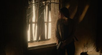 Movie still from “The Forever Purge” (2021), directed by Everardo Gout – A woman standing in front of a large window; Medium shot, Low angle