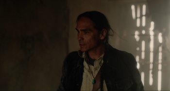 Movie still from “The Forever Purge” (2021), directed by Everardo Gout – A man with long black hair wearing a leather jacket; Close Up shot, Over the shoulder angle