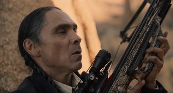 Movie still from “The Forever Purge” (2021), directed by Everardo Gout – A person holding a rifle; Close Up shot, Over the shoulder angle