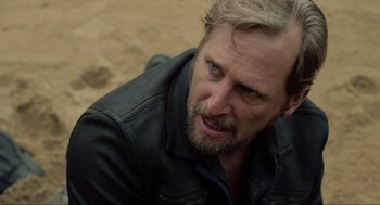 Movie still from “The Forever Purge” (2021), directed by Everardo Gout – A person wearing a jacket; Close Up shot, Over the shoulder angle