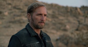 Movie still from “The Forever Purge” (2021), directed by Everardo Gout – A person wearing a jacket; Close Up shot, Over the shoulder angle