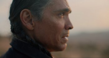 Movie still from “The Forever Purge” (2021), directed by Everardo Gout – An older man is looking off into the distance; Close Up shot, Over the shoulder angle