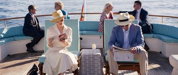 Movie still from “The Forgiven” (2021), directed by John Michael McDonagh – A man and a woman sitting on a boat; Medium shot, High angle