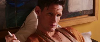 Movie still from “The Forgiven” (2021), directed by John Michael McDonagh – A person wearing a robe; Close Up shot, High angle