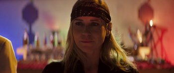 Movie still from “The Forgiven” (2021), directed by John Michael McDonagh – A person wearing a head scarf; Close Up shot, Low angle