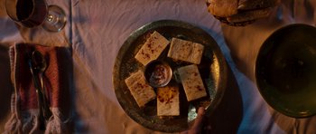 Movie still from “The Forgiven” (2021), directed by John Michael McDonagh – A plate of food on the table; Extreme Close Up shot, Overhead angle