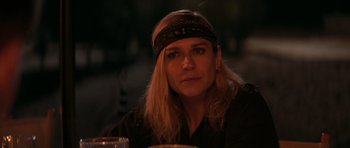 Movie still from “The Forgiven” (2021), directed by John Michael McDonagh – A person wearing a head band; Close Up shot, Over the shoulder angle