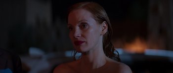 Movie still from “The Forgiven” (2021), directed by John Michael McDonagh – A person wearing a bra; Close Up shot, Over the shoulder angle