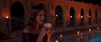 Movie still from “The Forgiven” (2021), directed by John Michael McDonagh – A woman is holding a cup in her hand; Medium shot, Over the shoulder angle