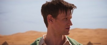 Movie still from “The Forgiven” (2021), directed by John Michael McDonagh – A person wearing a green shirt; Close Up shot, Over the shoulder angle