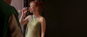 Movie still from “The Forgiven” (2021), directed by John Michael McDonagh – A woman drinking a glass of wine from a wine glass; Medium shot, Low angle