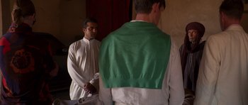 Movie still from “The Forgiven” (2021), directed by John Michael McDonagh – Two men standing next to each other in front of a mirror; Medium shot, Over the shoulder angle