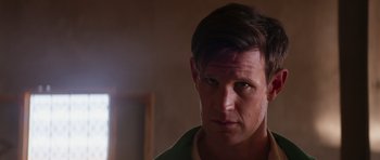 Movie still from “The Forgiven” (2021), directed by John Michael McDonagh – A person wearing a green shirt; Close Up shot, Over the shoulder angle