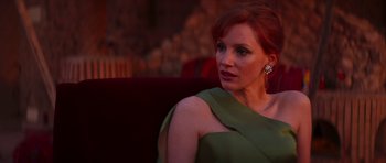 Movie still from “The Forgiven” (2021), directed by John Michael McDonagh – A person sitting on a couch; Close Up shot, Over the shoulder angle