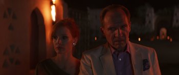 Movie still from “The Forgiven” (2021), directed by John Michael McDonagh – A man and a woman standing next to each other in front of a building; Close Up shot, Over the shoulder angle