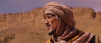 Movie still from “The Forgiven” (2021), directed by John Michael McDonagh – A person wearing a turban; Close Up shot, Low angle