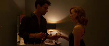 Movie still from “The Forgiven” (2021), directed by John Michael McDonagh – A man and a woman are holding wine glasses; Medium shot, Over the shoulder angle