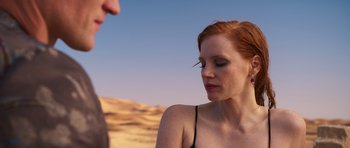 Movie still from “The Forgiven” (2021), directed by John Michael McDonagh – A beautiful woman with red hair standing next to a man; Close Up shot, Over the shoulder angle