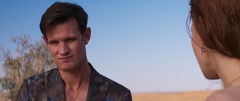 Movie still from “The Forgiven” (2021), directed by John Michael McDonagh – A person wearing a suit jacket; Close Up shot, Over the shoulder angle