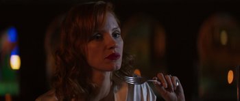 Movie still from “The Forgiven” (2021), directed by John Michael McDonagh – A woman holding a fork in her hand; Close Up shot, Over the shoulder angle