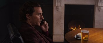 Movie still from “The Gentlemen” (2019), directed by Guy Ritchie – A person talking on a cell phone; Close Up shot, Over the shoulder angle