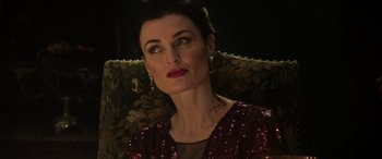 Movie still from “The Gentlemen” (2019), directed by Guy Ritchie – A person sitting on a chair; Close Up shot, High angle