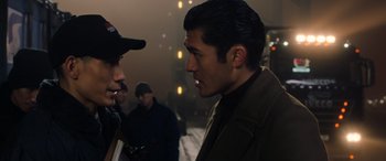 Movie still from “The Gentlemen” (2019), directed by Guy Ritchie – Two men are facing each other in the dark; Close Up shot, Over the shoulder angle