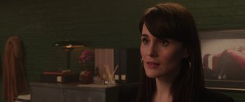 Movie still from “The Gentlemen” (2019), directed by Guy Ritchie – A person wearing a suit and tie; Close Up shot, Over the shoulder angle