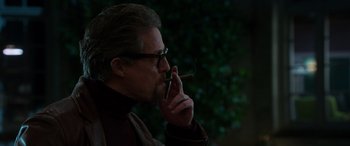 Movie still from “The Gentlemen” (2019), directed by Guy Ritchie – A person holding a cigarette in his mouth; Close Up shot, Low angle