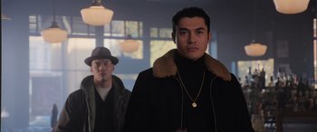 Movie still from “The Gentlemen” (2019), directed by Guy Ritchie – A man in a black jacket and a man in a brown jacket; Medium shot, Low angle