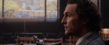 Movie still from “The Gentlemen” (2019), directed by Guy Ritchie – A man's face in front of a window; Close Up shot, Over the shoulder angle