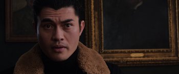 Movie still from “The Gentlemen” (2019), directed by Guy Ritchie – A person wearing a coat; Close Up shot, Low angle