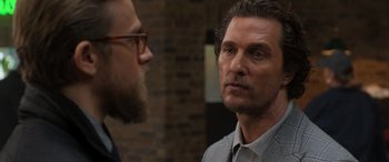 Movie still from “The Gentlemen” (2019), directed by Guy Ritchie – A man with a goatee and a beard talking to another man with a goatee; Close Up shot, Over the shoulder angle