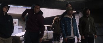 A group of people standing next to each other near a car