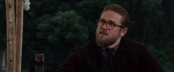 Movie still from “The Gentlemen” (2019), directed by Guy Ritchie – A man with a beard and glasses looking up; Close Up shot, Over the shoulder angle
