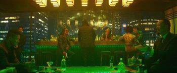 Movie still from “Deadpool 2” (2018), directed by David Leitch – Two people are sitting at a bar in front of a window; Wide shot, High angle