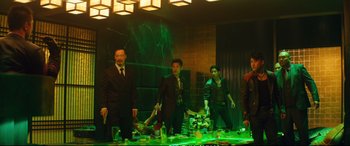 Movie still from “Deadpool 2” (2018), directed by David Leitch – A group of people standing around a table; Wide shot, High angle