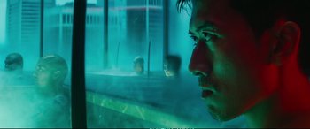 Movie still from “Deadpool 2” (2018), directed by David Leitch – A man looking out of a window at a building; Close Up shot, Over the shoulder angle