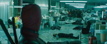 Movie still from “Deadpool 2” (2018), directed by David Leitch – A group of people laying on the ground in a room; Wide shot, High angle