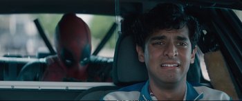 Movie still from “Deadpool 2” (2018), directed by David Leitch – A man sitting in the back seat of a car; Close Up shot, Over the shoulder angle