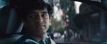 Movie still from “Deadpool 2” (2018), directed by David Leitch – A man's face in front of a traffic light; Close Up shot, Over the shoulder angle