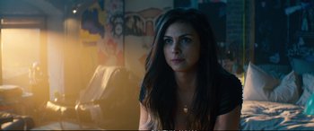 Movie still from “Deadpool 2” (2018), directed by David Leitch – A beautiful woman with long dark hair sitting in a room; Close Up shot, Over the shoulder angle