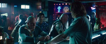Movie still from “Deadpool 2” (2018), directed by David Leitch – A group of men sitting at a bar drinking beer; Medium shot, Over the shoulder angle