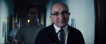 Movie still from “Deadpool 2” (2018), directed by David Leitch – A man in a suit and tie standing next to another man; Close Up shot, Over the shoulder angle