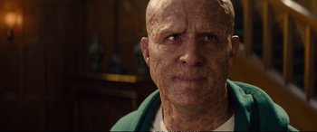 Movie still from “Deadpool 2” (2018), directed by David Leitch – An old man with a shaved head is looking at the camera; Close Up shot, Low angle