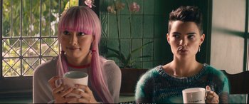 Movie still from “Deadpool 2” (2018), directed by David Leitch – Two women sitting next to each other holding a cup; Close Up shot, Over the shoulder angle