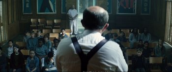 Movie still from “Deadpool 2” (2018), directed by David Leitch – A group of people sitting in front of an audience; Medium shot, Over the shoulder angle